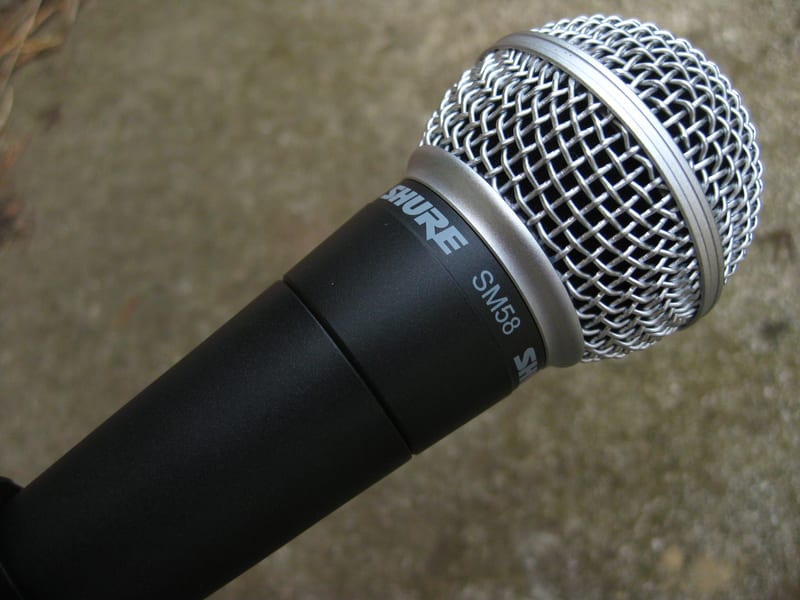 Shure SM58 dynamic vocal microphone in matte black with its spherical steel mesh grille